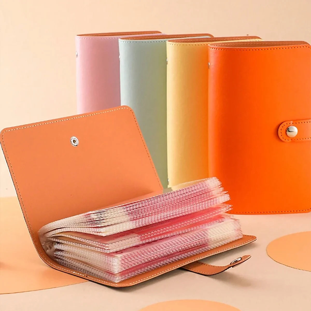 A set of colorful cash organizers and ledger folders with envelope sleeves displayed on a light surface.