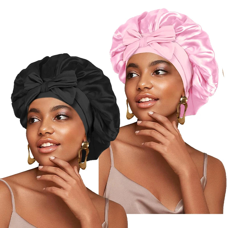 A woman models a pink satin sleeping cap with an adjustable tie band.