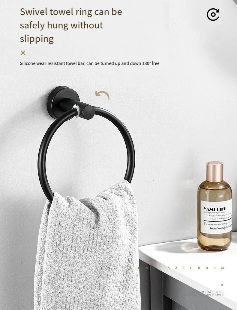 A black towel ring is safely hung on a white wall, demonstrating its ability to be turned up and down.