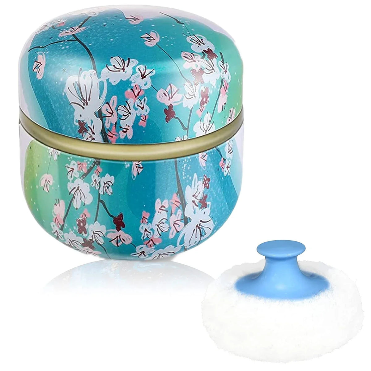 Runde Kosmettkasten mit Deckel, blauer Hintergrund und rosa Blumenmuster, neben einem weißen Kosmetiksp