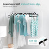 A display of various clothing items hanging on a chrome non-slip velvet hanger rack.