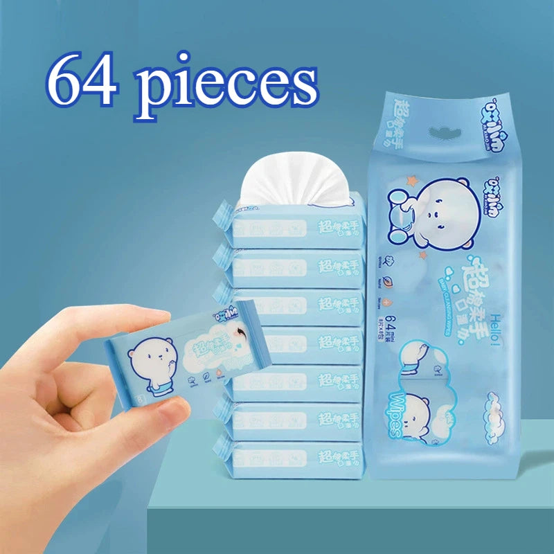 A hand is holding a stack of 64 individual mini wipes packaged in a clear blue plastic container.