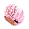 Pink satin sleep cap with a gathered edge and a black tie for curly hair