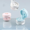 A set of portable multi-tool organizers for dental appliances shown in pink and light blue plastic containers.
