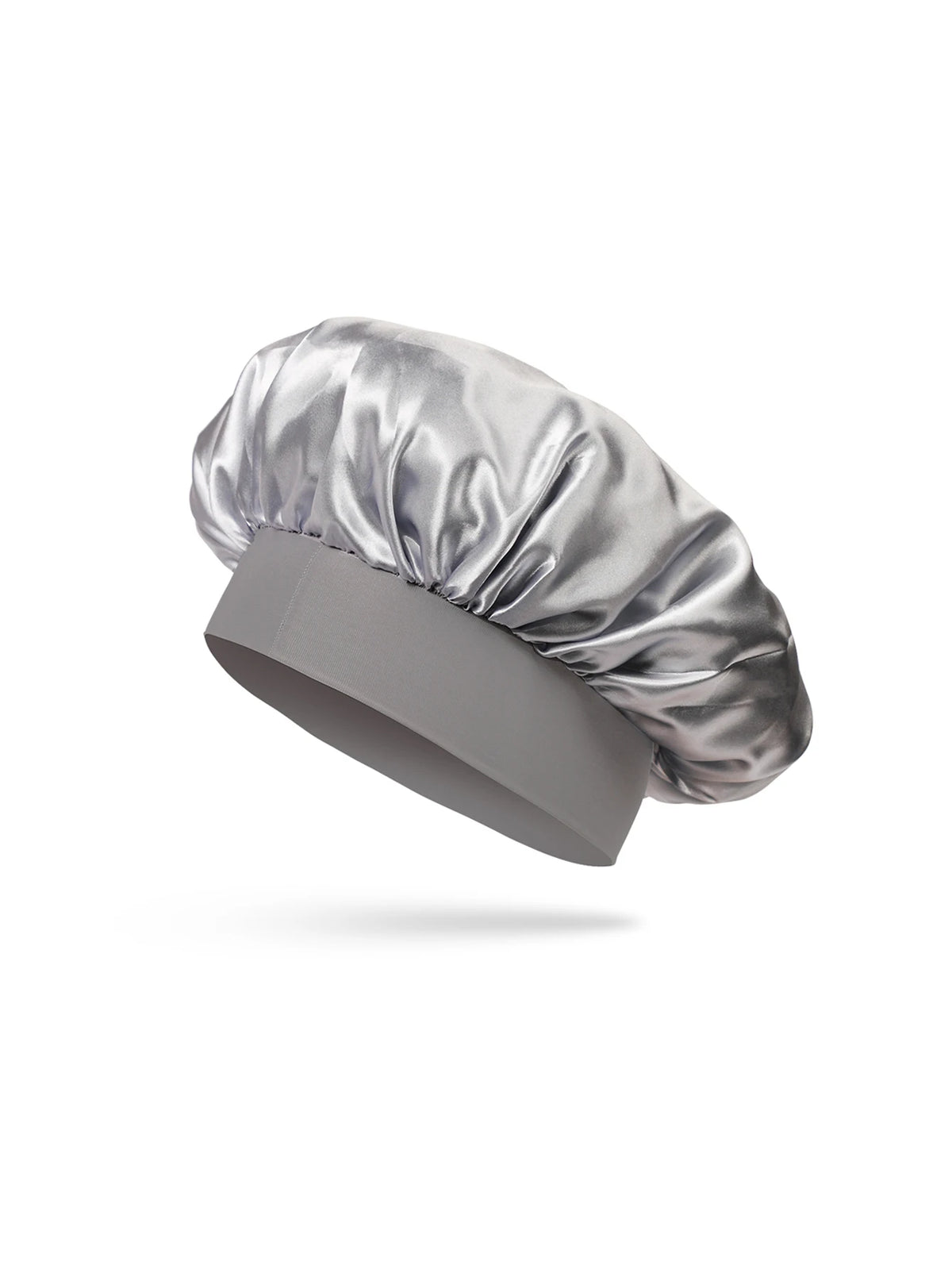 A silver satin sleep bonnet for toddlers, folded and displayed on a gray fabric base.