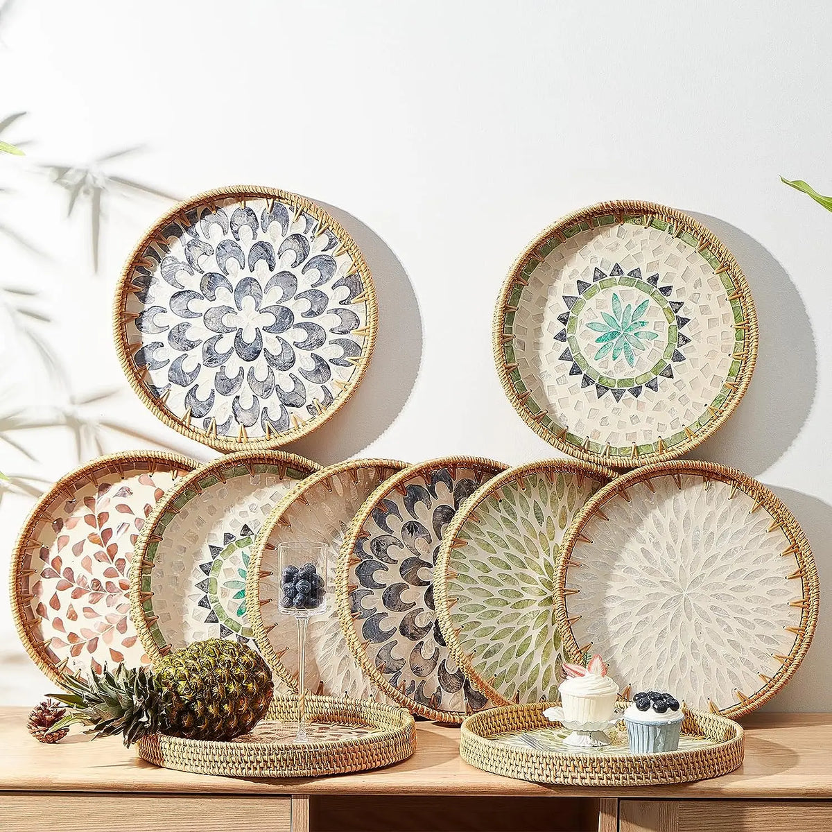 Round rattan serving tray with mother of pearl inlay featuring various natural and muted tones.