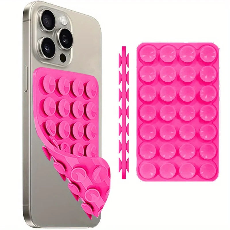 A silver smartphone is shown next to a pink silicone suction cup phone mount for hands-free selfies and videos.