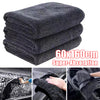Stack of dark gray microfiber car cleaning and drying towels demonstrating super-absorption.