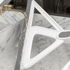 A white silicone window and surface cleaner is shown being used to clean a marble countertop.