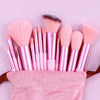 A collection of pink and nude luxury vegan makeup brushes displayed on a pink towel.