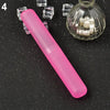A pink travel and storage toothbrush case is shown next to several clear glass cubes and a small glass jar filled with white 