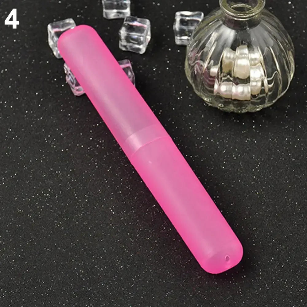 A pink travel and storage toothbrush case is shown next to several clear glass cubes and a small glass jar filled with white 