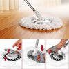 Close-up view of replacement microfiber spin mop heads being used on a wooden floor.