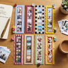 A set of colorful magnetic photo frames displayed on a wooden surface.