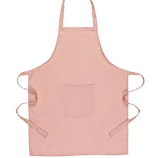 A light pink unisex server apron with utility pockets