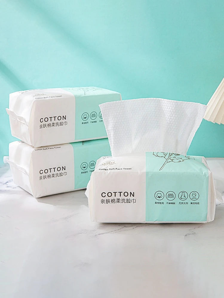 A display of packaged cotton face towels for makeup and cleansing products on a white surface.