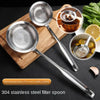 A stainless steel filter spoon is shown with various food items and a citrus slice on a wooden cutting board.