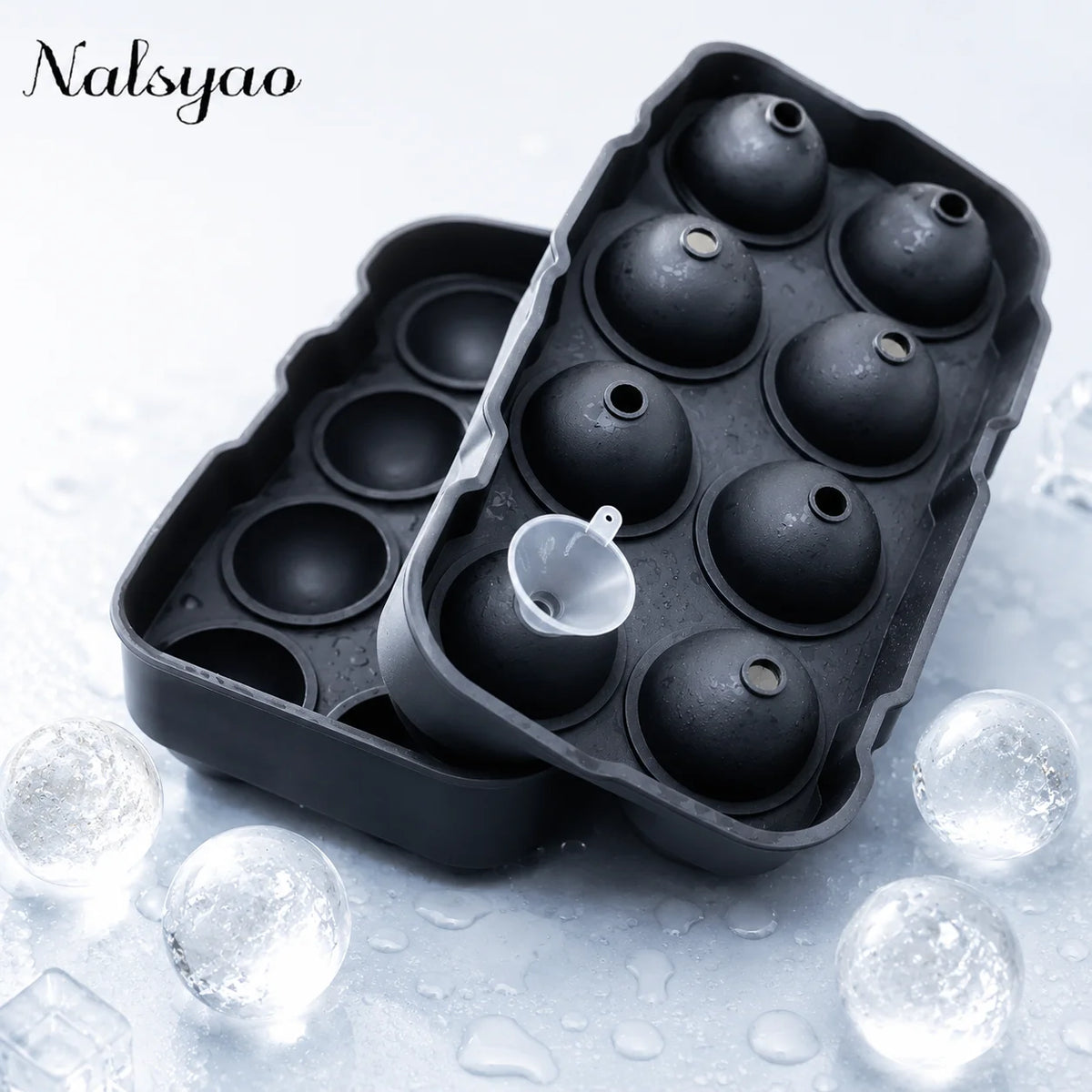 A black silicone sphere ice mold is shown with several spherical ice molds, resting on a wet surface.