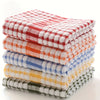 A stack of absorbent cotton cleaning cloths featuring a red and white plaid pattern.