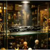A black willow stick night light projector displayed on a glass shelf among collectible figures.