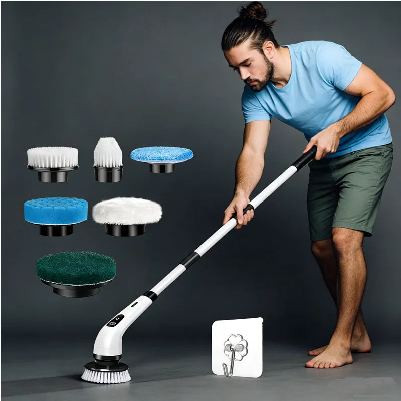 A man is using a cordless electric spin scrubber and various cleaning brushes on a gray floor.