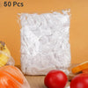 A clear plastic bag filled with 50 reusable disposable food covers featuring decorative bows, next to some tomatoes.