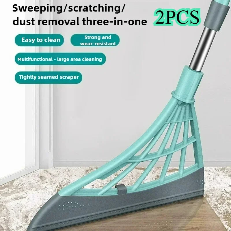 A teal and gray three-in-one cleaning tool with a scraper head is shown on a wooden surface.
