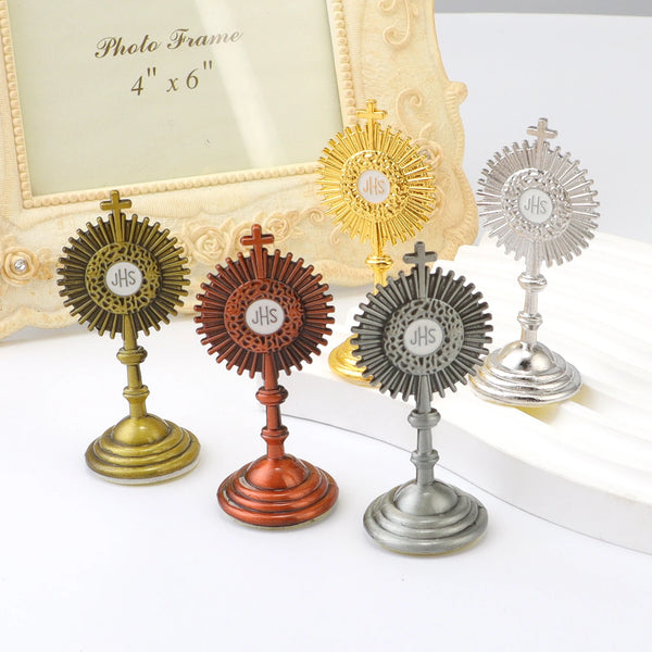 Four mini metal religious ornaments in gold and silver tones displayed on a white surface.