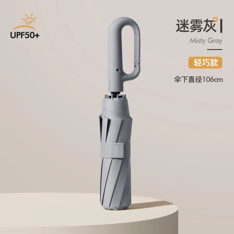 A silver automatic folding umbrella with a handle and reinforced shaft is shown against a light background.