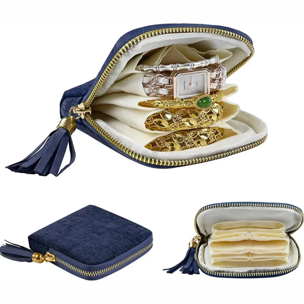 A navy blue velvet jewelry storage pouch set with a zipper and tassel, showing stacked gold and silver jewelry inside.