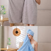 A woman is shown using a thick blue microfiber bath towel in a bright, modern bathroom setting.