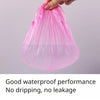 A hand is holding a clear pink reusable shower cap made of plastic film.