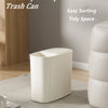 A white sleek open-top trash can with a press lid sitting on a light rug in a modern room.