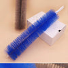 A bright blue ceiling fan cleaning brush is shown next to a gray brush and a white box.