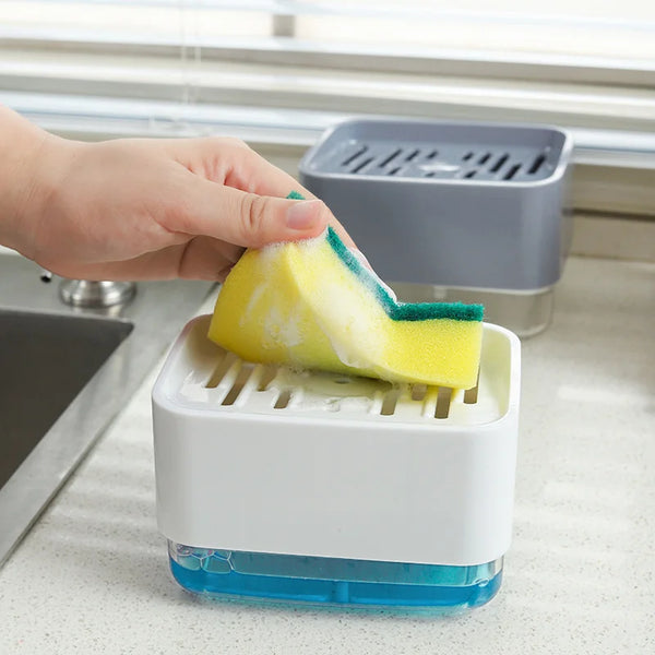 A hand is placing a yellow sponge into a white kitchen dish soap dispenser with a blue base.