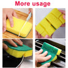 Yellow and green double-sided scouring sponges being used for kitchen cleaning.