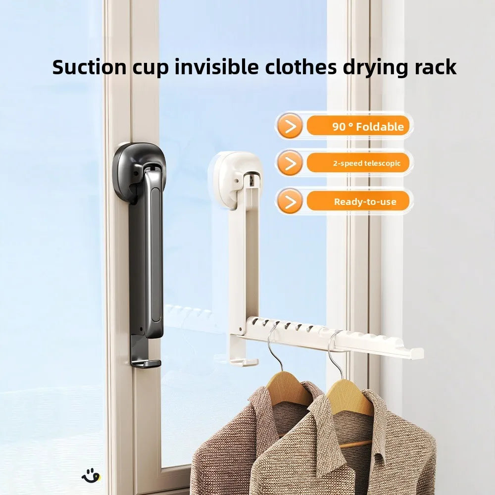 A white folding wall drying rack with suction cups is shown hanging clothes in a window frame.