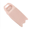 A pink thickened washboard for delicate laundry with ridges and a wavy section.
