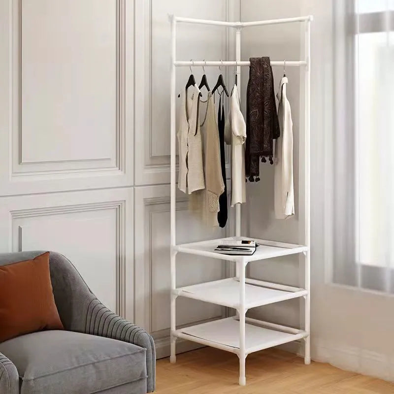 A white multi-layer corner coat rack with wooden hangers and storage shelves in a bright room.