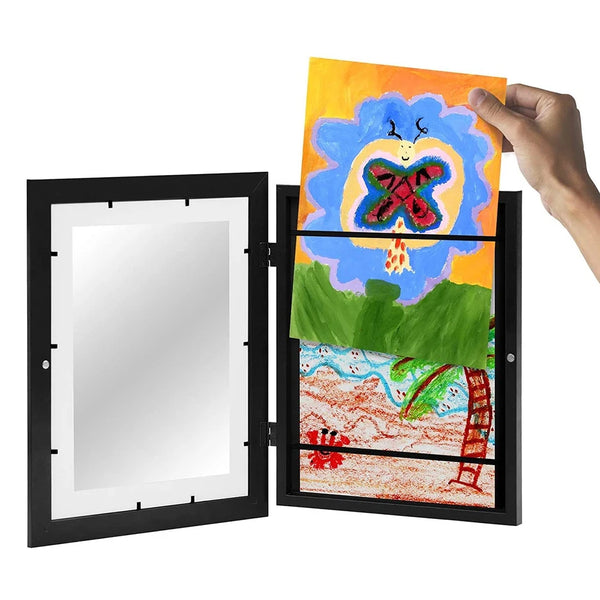 A hand holds an open magnetic art frame displaying a colorful painting of a butterfly and a landscape.