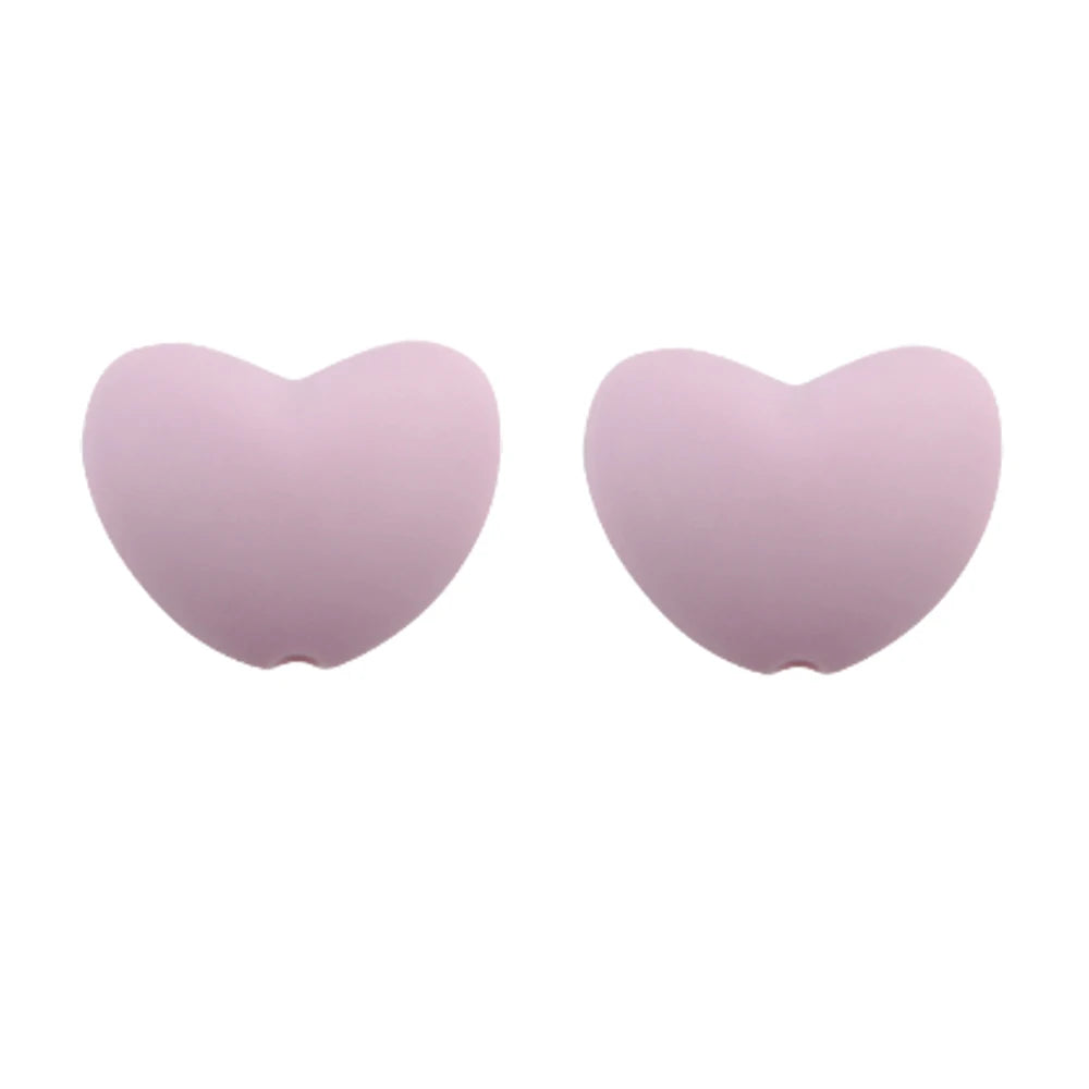 A pair of light purple silicone heart charm beads for DIY jewelry.