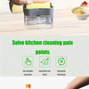 A portable press-type liquid soap dispenser in clear plastic is shown with various cleaning tools and dishes.