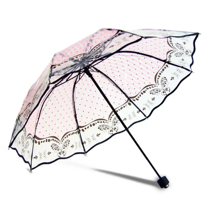 A retro transparent folding umbrella with pink and white lace-like patterns.