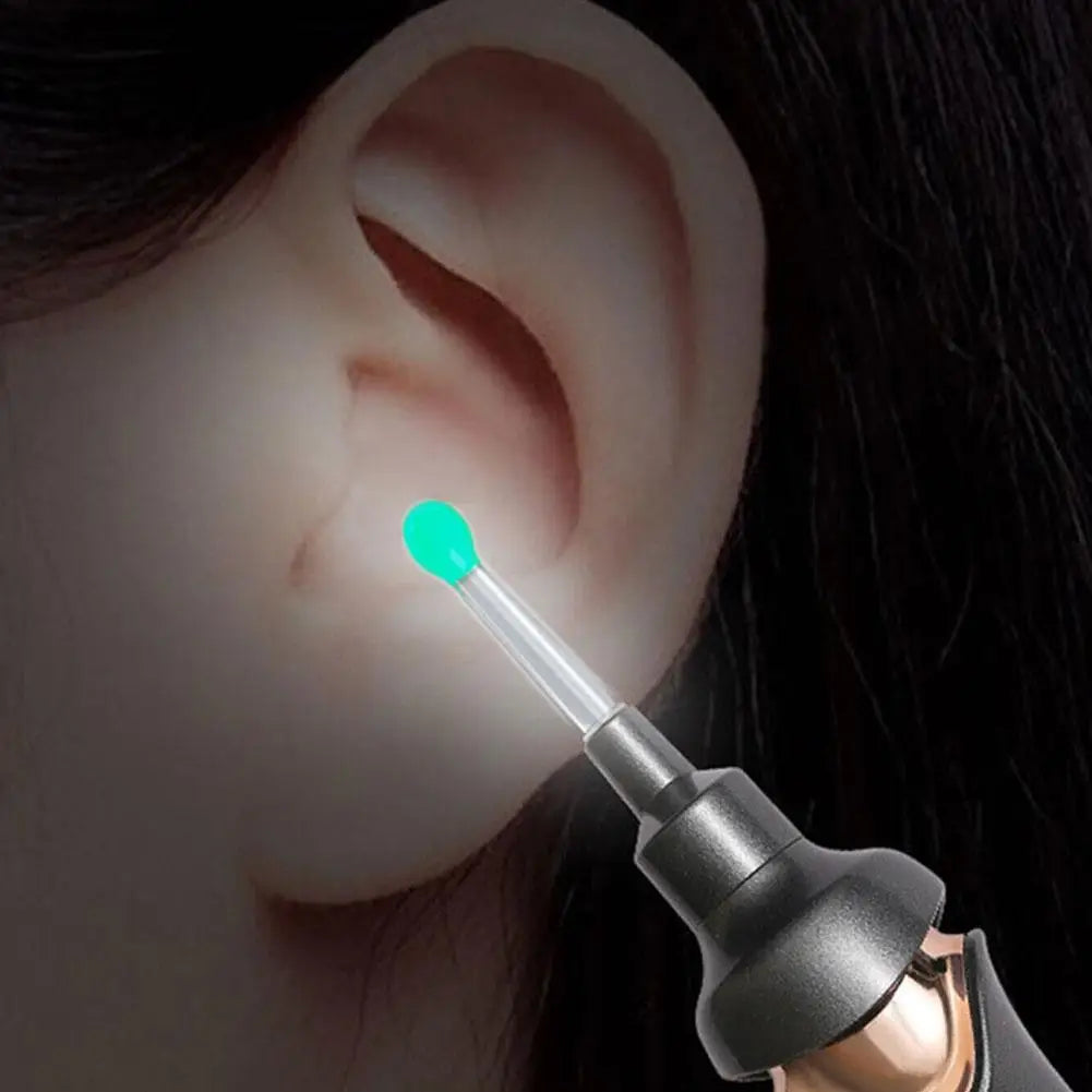 A replacement ear spoon with a bright green tip is shown being used in an otoscope for cleaning.