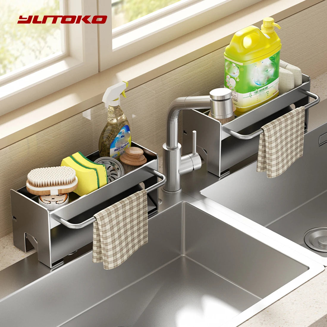 A stainless steel kitchen sink caddy with a draining tray holds sponges, dish tools, and cleaning liquids.