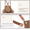 A brown canvas apron featuring cross-anti-falling straps and metal accessories.