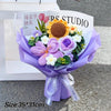 A purple handmade crochet flower bouquet featuring a large yellow sunflower and various purple and white flowers.