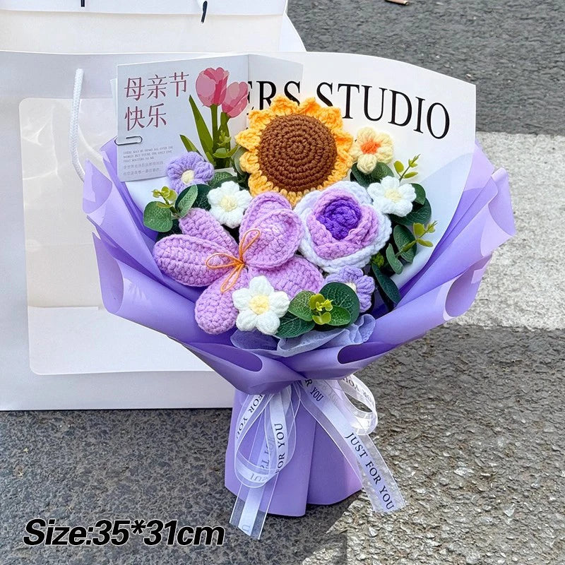 A purple handmade crochet flower bouquet featuring a large yellow sunflower and various purple and white flowers.