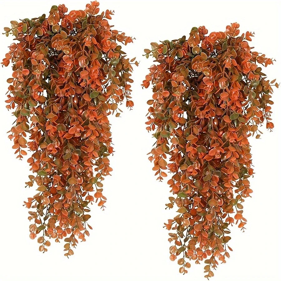 Artificial flower garland featuring reddish-orange leaves cascading down