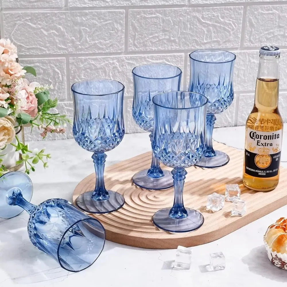 A collection of blue glass champagne flutes and a bottle of Coronita Extra on a wooden board.